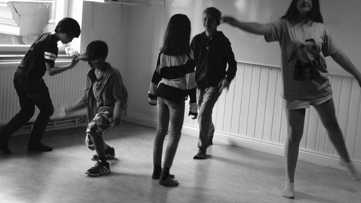 En grupp barn som dansar i ett rum.